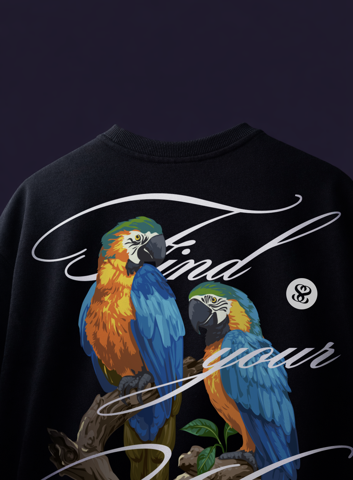 Black sweatshirt with colorful parrot design and 'Find your' text on a dark background