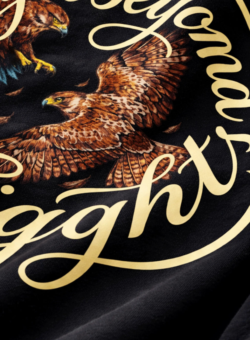 Close-up of a black fabric with gold text and two eagles.