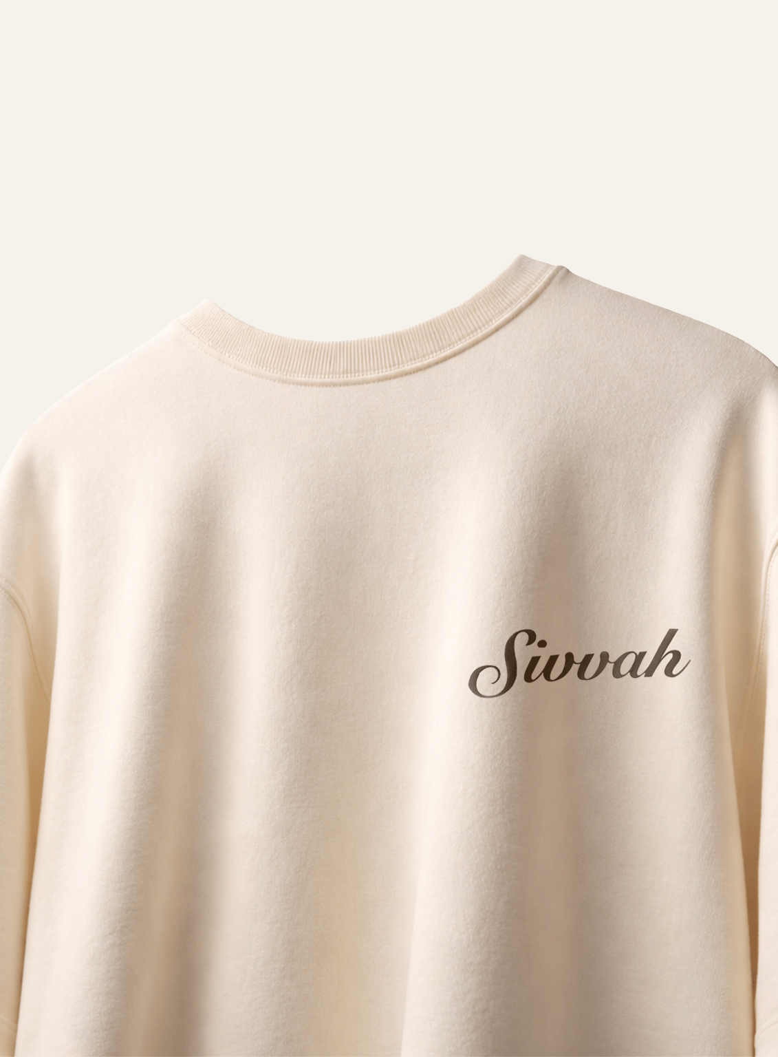 Beige sweatshirt with 'Sivvah' text on a light gray background