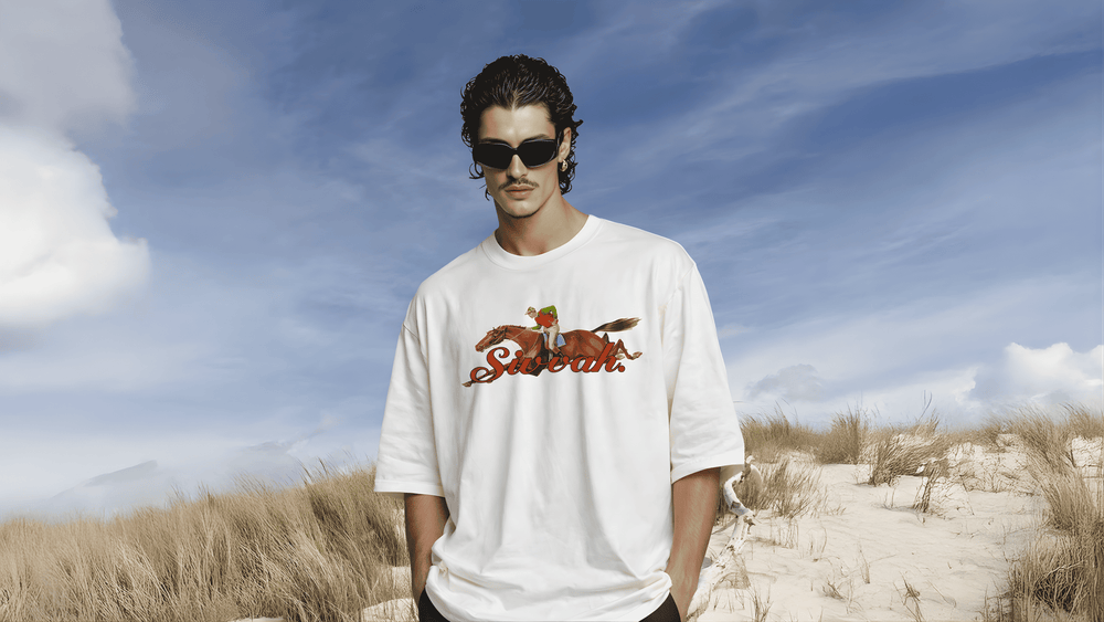 Man wearing a white t-shirt with a logo on a beach